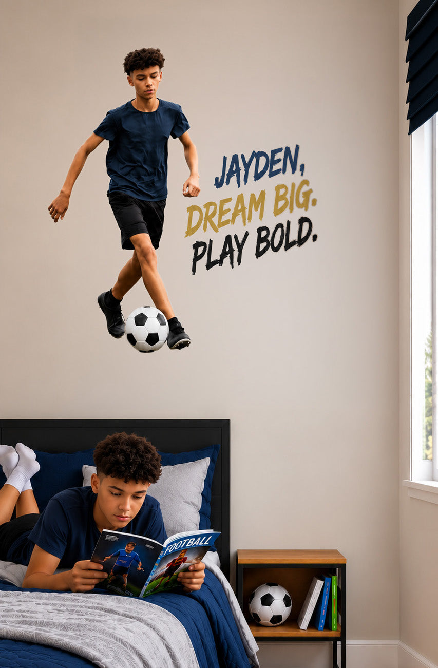 Personalised football wall sticker of a boy dribbling a ball with the words “Jayden, Dream big. Play bold.” in his bedroom.