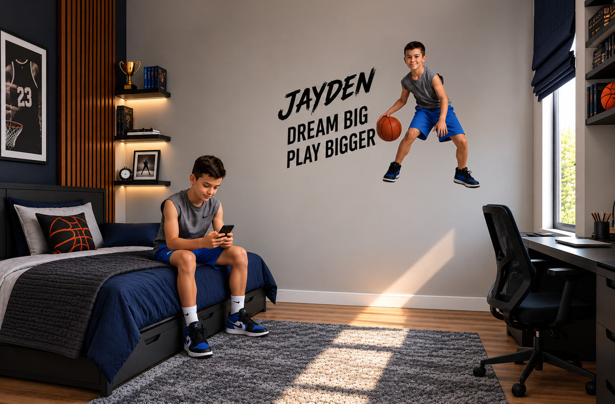Custom basketball wall sticker featuring a boy jumping with a basketball and the motivational words “Jayden, Dream Big, Play Bigger” in a sports-themed bedroom.