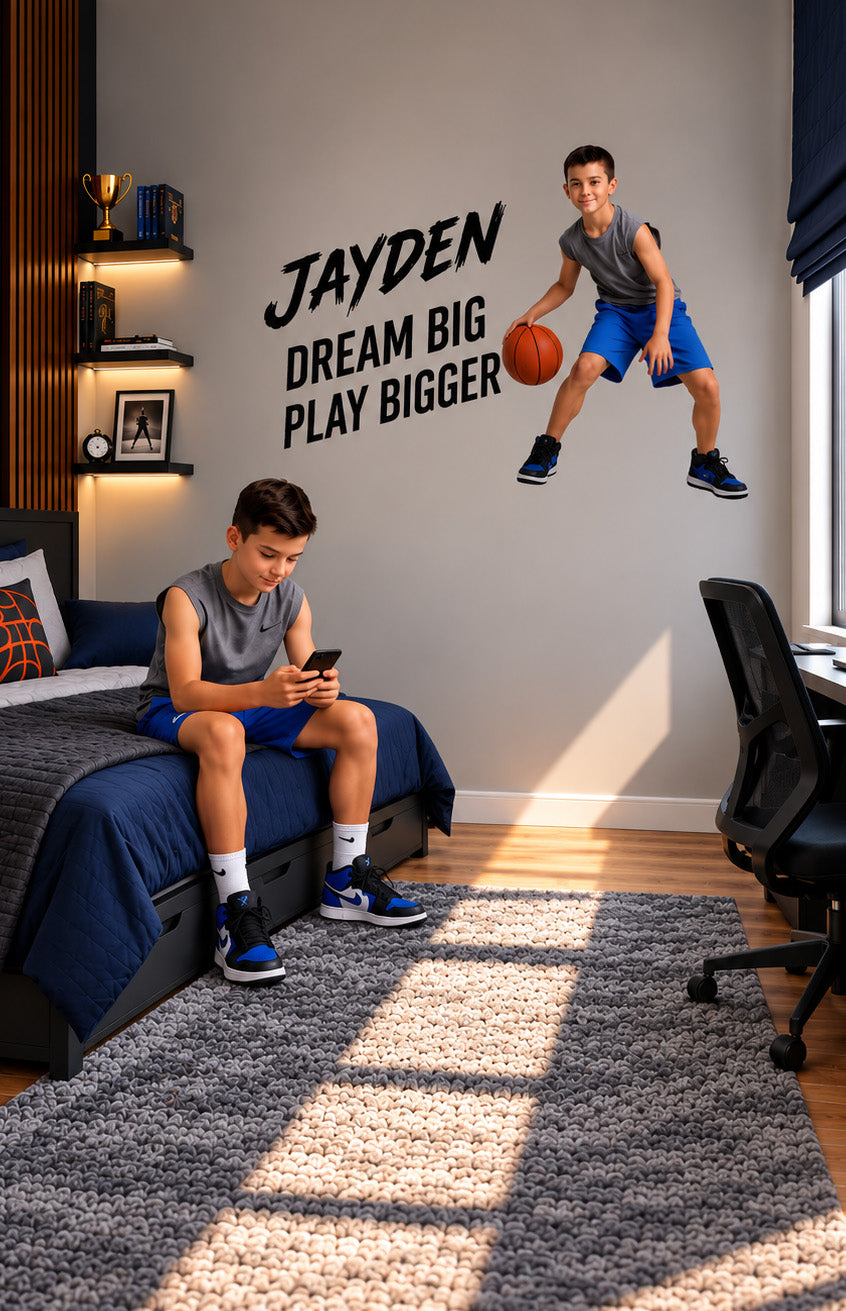 Custom basketball wall sticker featuring a boy jumping with a basketball and the motivational words “Jayden, Dream Big, Play Bigger” in a sports-themed bedroom.